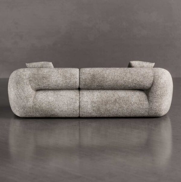 Back view of a luxury curved 3-seater sofa with a smooth sculptural backrest and rounded arm design, upholstered in textured bouclé fabric, ideal for modern luxury homes in Dubai and Abu Dhabi UAE.