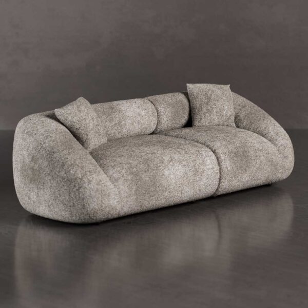 Side angle of a luxury organic-shaped sofa with soft rounded edges, deep cushioned seats, and curved arms in premium bouclé upholstery, designed for contemporary living rooms in Dubai and Abu Dhabi UAE.