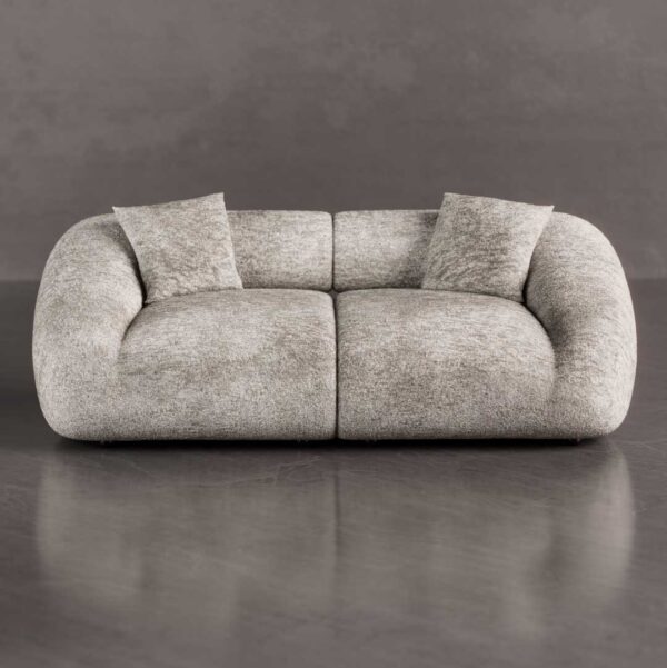 Front view of a luxury modern curved sofa with oversized rounded arms and deep cloud-like seating in textured bouclé fabric, a sculptural statement piece for luxury homes in Dubai and Abu Dhabi UAE.