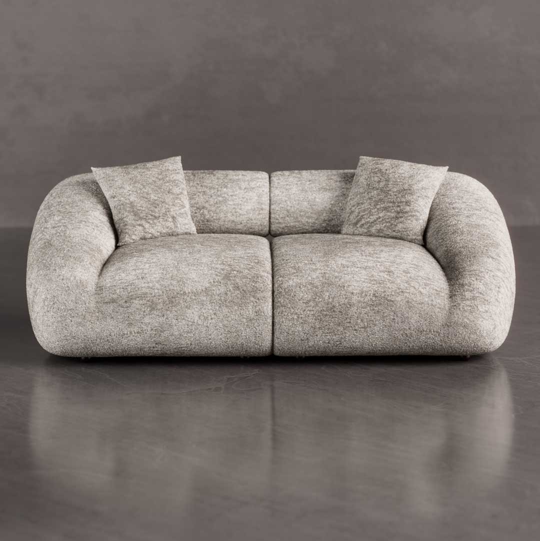 Front view of a luxury modern curved sofa with oversized rounded arms and deep cloud-like seating in textured bouclé fabric, a sculptural statement piece for luxury homes in Dubai and Abu Dhabi UAE.
